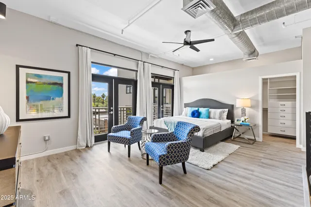 a bedroom with a bed and a chair