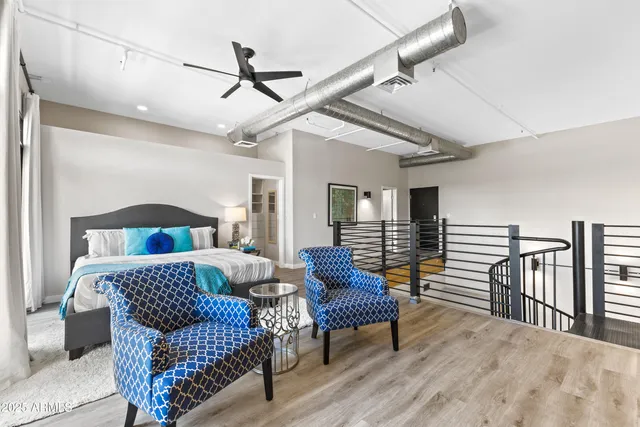 a bedroom with furniture and a wooden floor