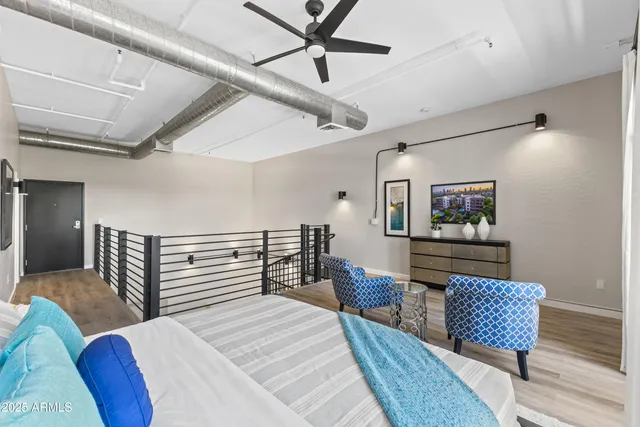 a bedroom with a bed and a lounge chair