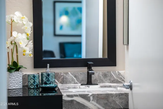 a bathroom with a granite countertop sink a toilet and a mirror