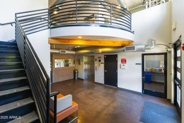 a view of a hallway with wooden cabinet and living room
