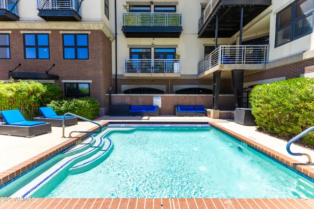 a view of swimming pool with a lounge chairs