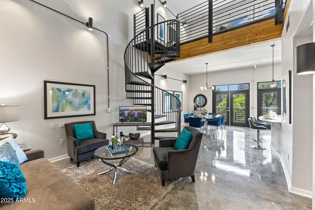 a living room with stainless steel appliances kitchen island granite countertop furniture and a dining table