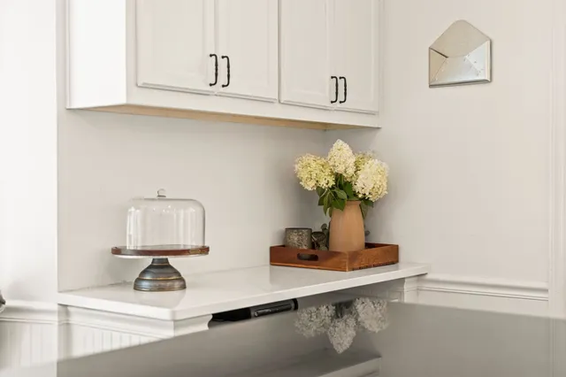 a table with a vase and flowers on it