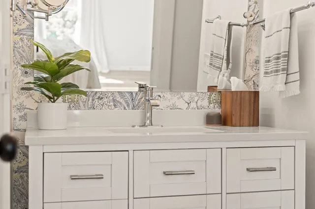 a bathroom with a sink and a mirror