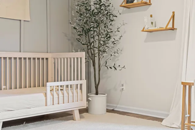 a white bath tub sitting next to a white wall