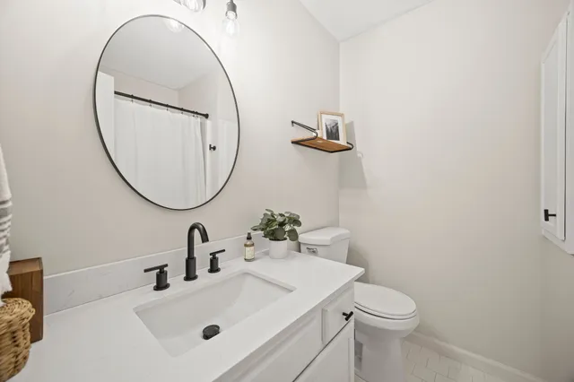 a bathroom with a sink a mirror and a toilet