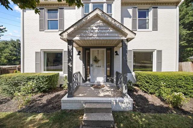 a front view of a house with garden