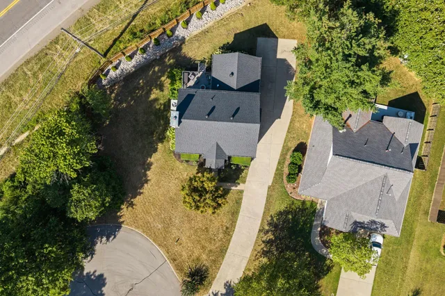 an aerial view of a house with a yard