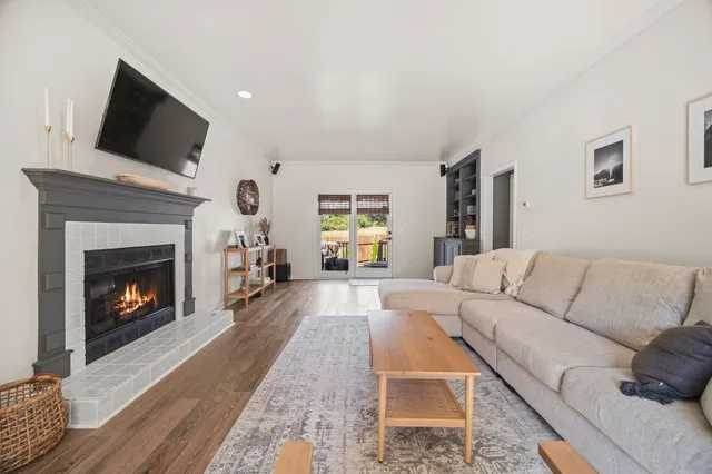 a living room with furniture a flat screen tv and a fireplace