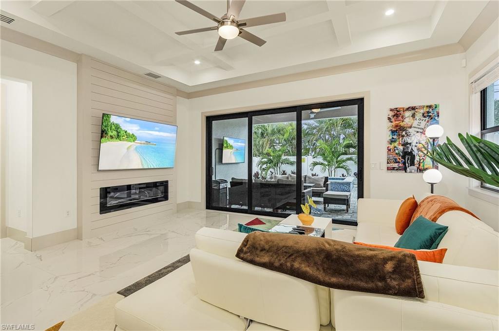 614 105th Avenue North Naples, FL 34108 - Photo 12 of 37 a living room with furniture and a flat screen tv