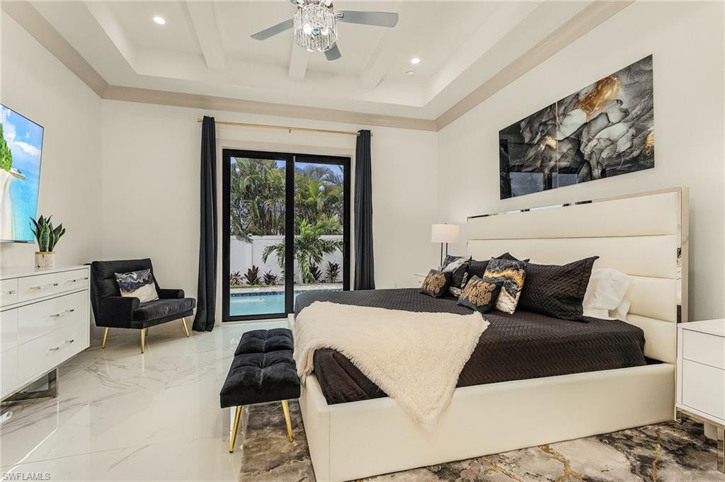 614 105th Avenue North Naples, FL 34108 - Photo 14 of 37 a bedroom with a bed and wooden floor