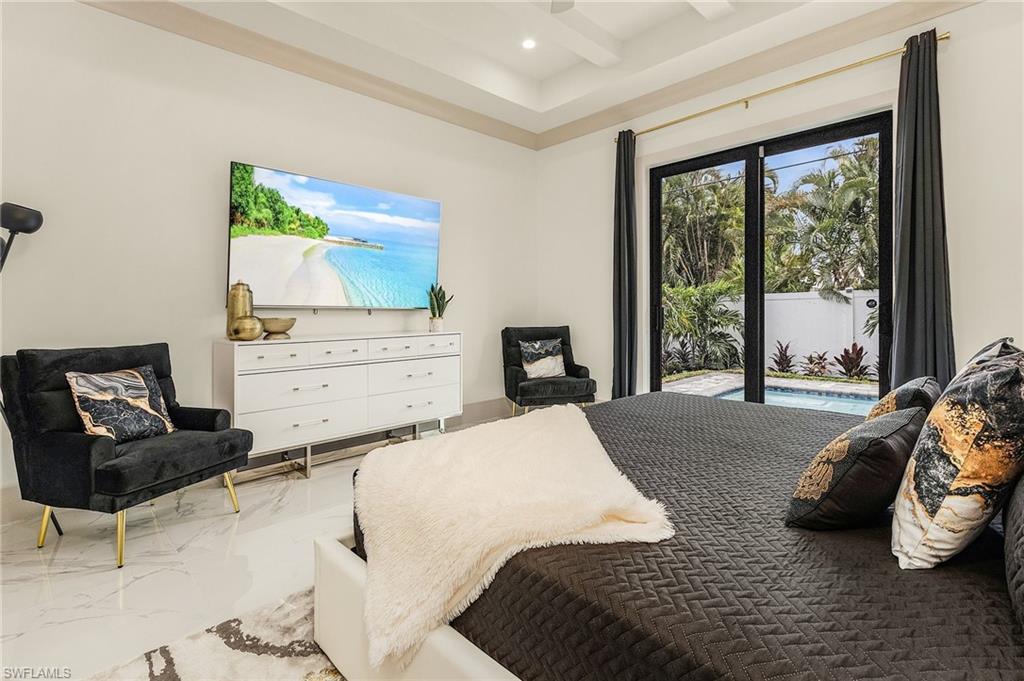 614 105th Avenue North Naples, FL 34108 - Photo 15 of 37 a bedroom with a bed and a couch