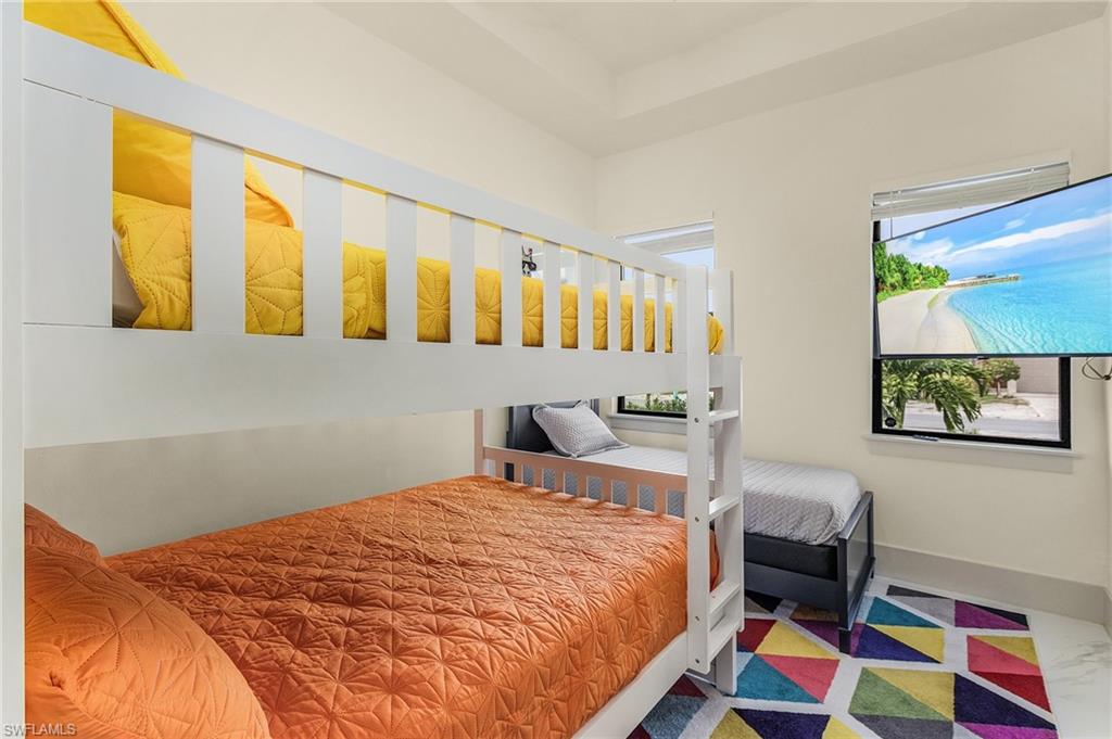 614 105th Avenue North Naples, FL 34108 - Photo 20 of 37 a bedroom with a bed and a painting on the wall