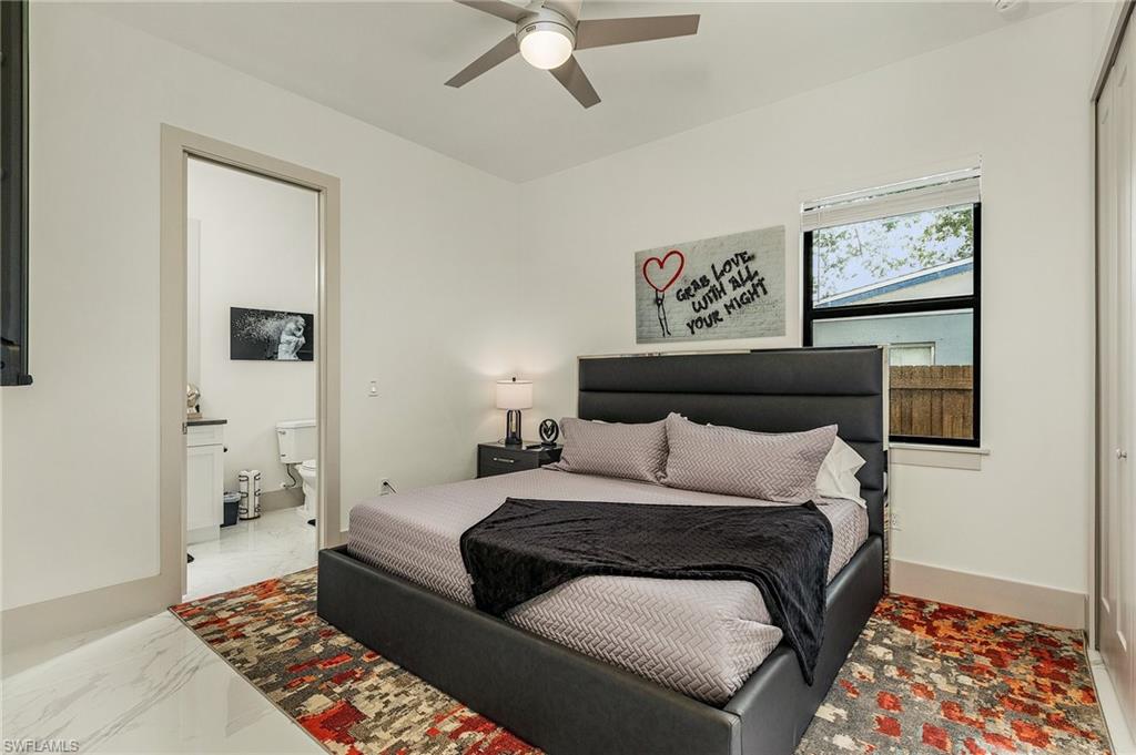 614 105th Avenue North Naples, FL 34108 - Photo 21 of 37 a bedroom with a bed and a lamp