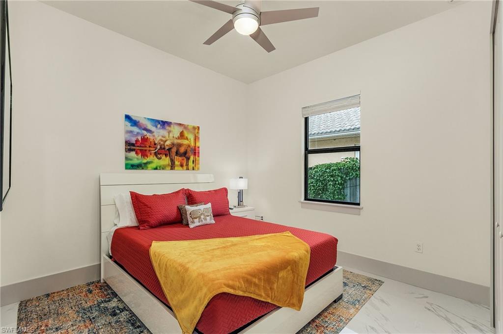 614 105th Avenue North Naples, FL 34108 - Photo 22 of 37 a bedroom with a bed and a painting on the wall