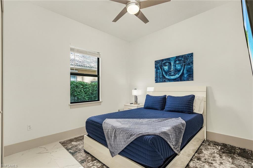 614 105th Avenue North Naples, FL 34108 - Photo 23 of 37 a bedroom with a large bed and a window