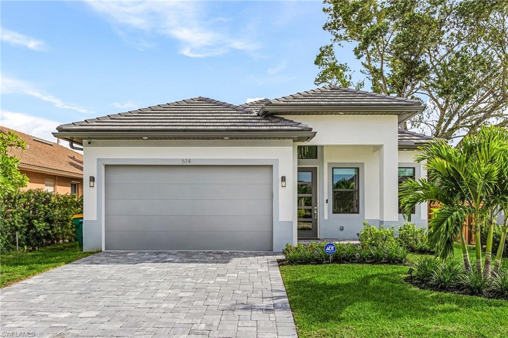614 105th Avenue North Naples, FL 34108 - Photo 32 of 37 a front view of a house with a garden