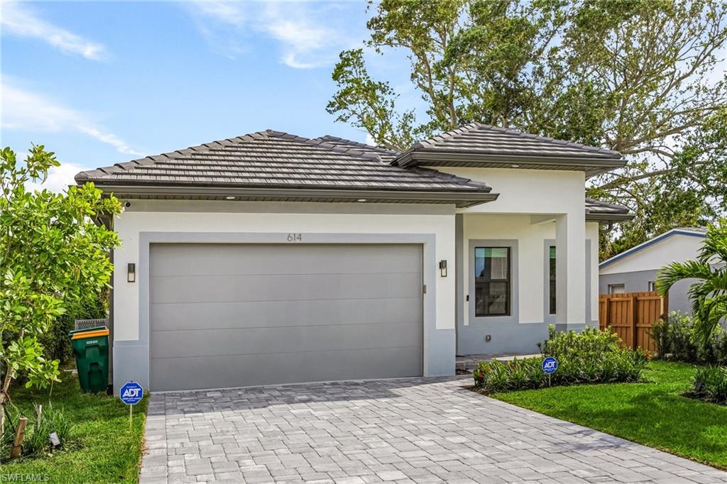 614 105th Avenue North Naples, FL 34108 - Photo 33 of 37 a front view of a house with garden