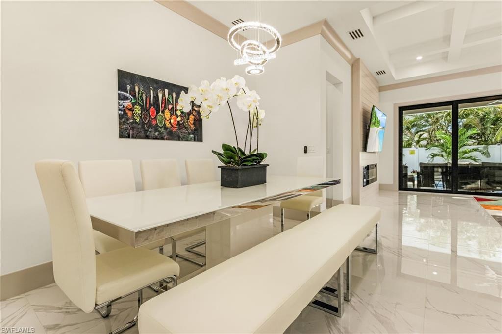 614 105th Avenue North Naples, FL 34108 - Photo 10 of 37 a living room with furniture and a chandelier