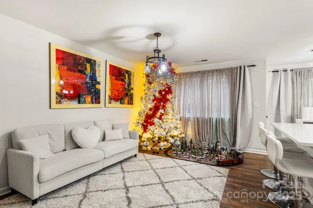 a living room with furniture and a chandelier