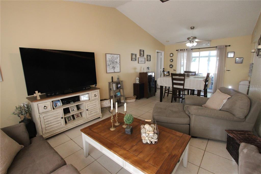 5046 Kenmore Street Spring Hill, FL 34608 - Photo 8 of 19 a living room with furniture and a flat screen tv