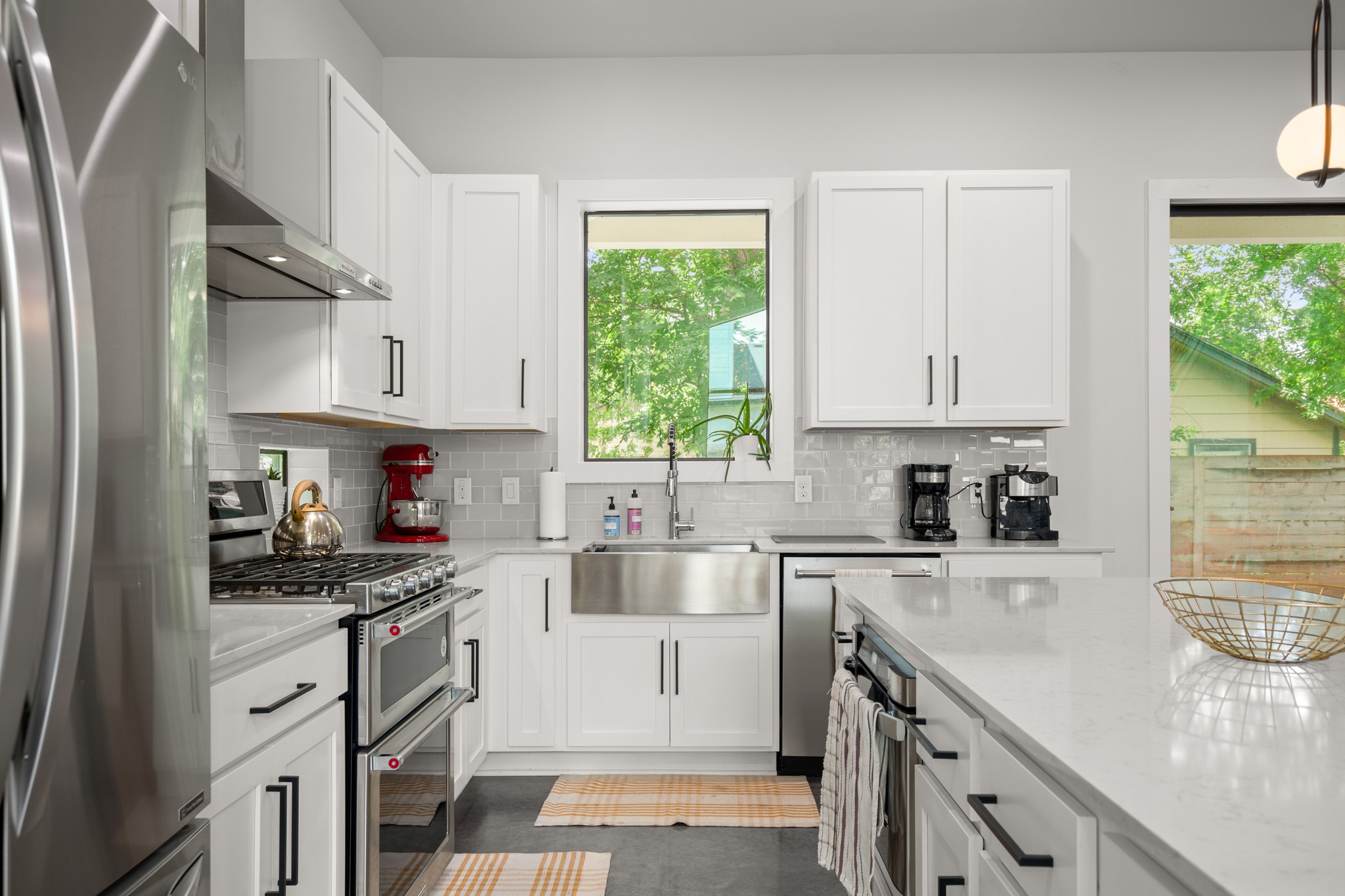 611 Gaylor Street, Unit 2 Austin, TX 78752 - Photo 17 of 31 Kitchen featuring appliances with stainless steel finishes, ventilation hood, and white cabinetry