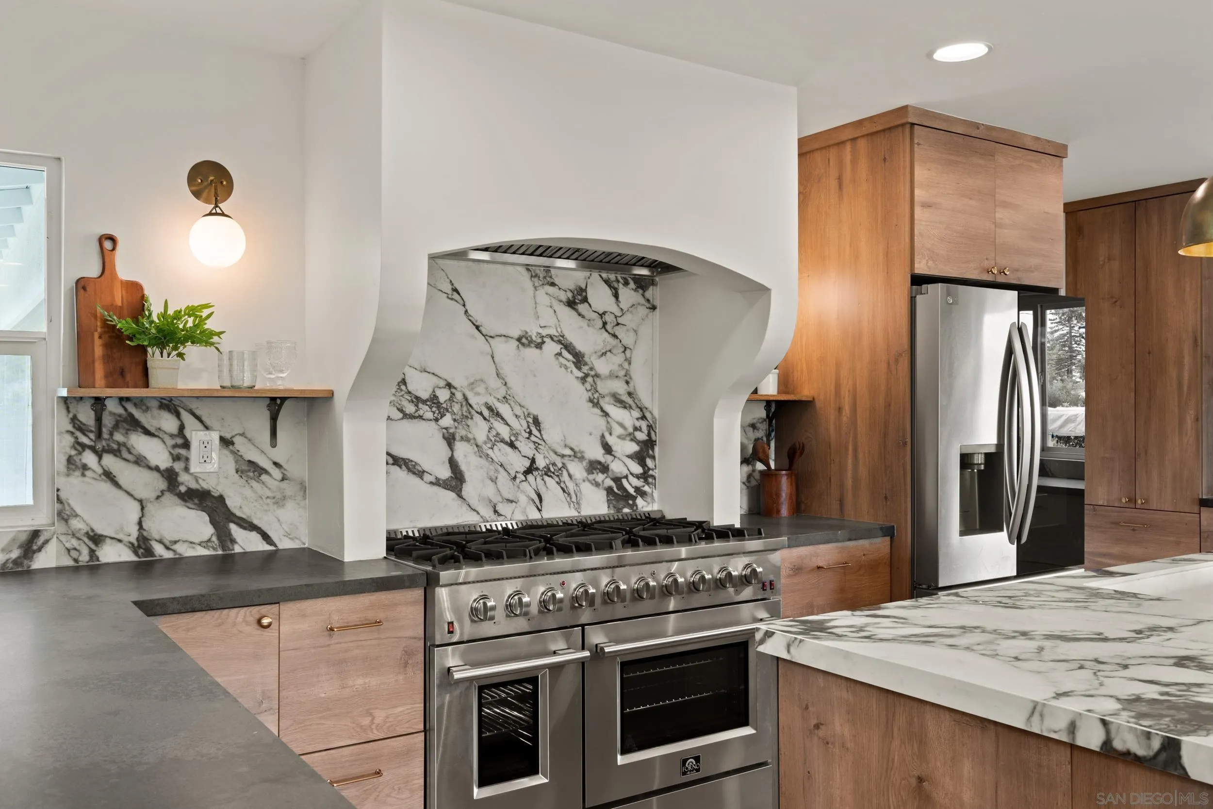 1144 Stratford Drive Encinitas, CA 92024 - Photo 11 of 39 a kitchen with stainless steel appliances granite countertop a stove and a refrigerator