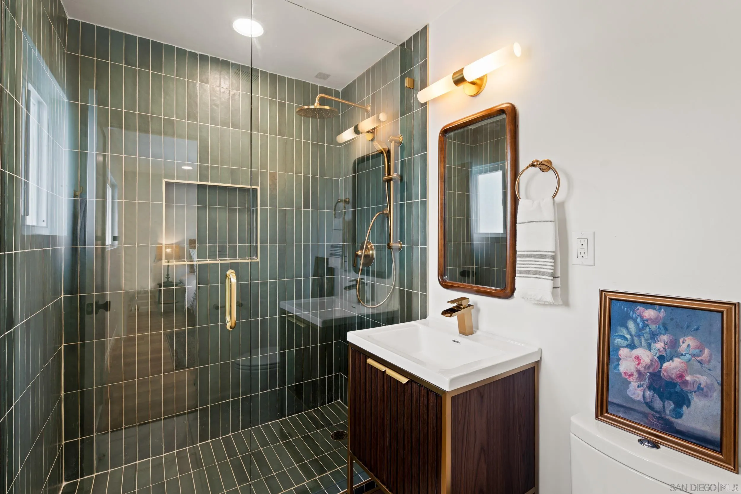 1144 Stratford Drive Encinitas, CA 92024 - Photo 18 of 39 a bathroom with a shower sink and mirror