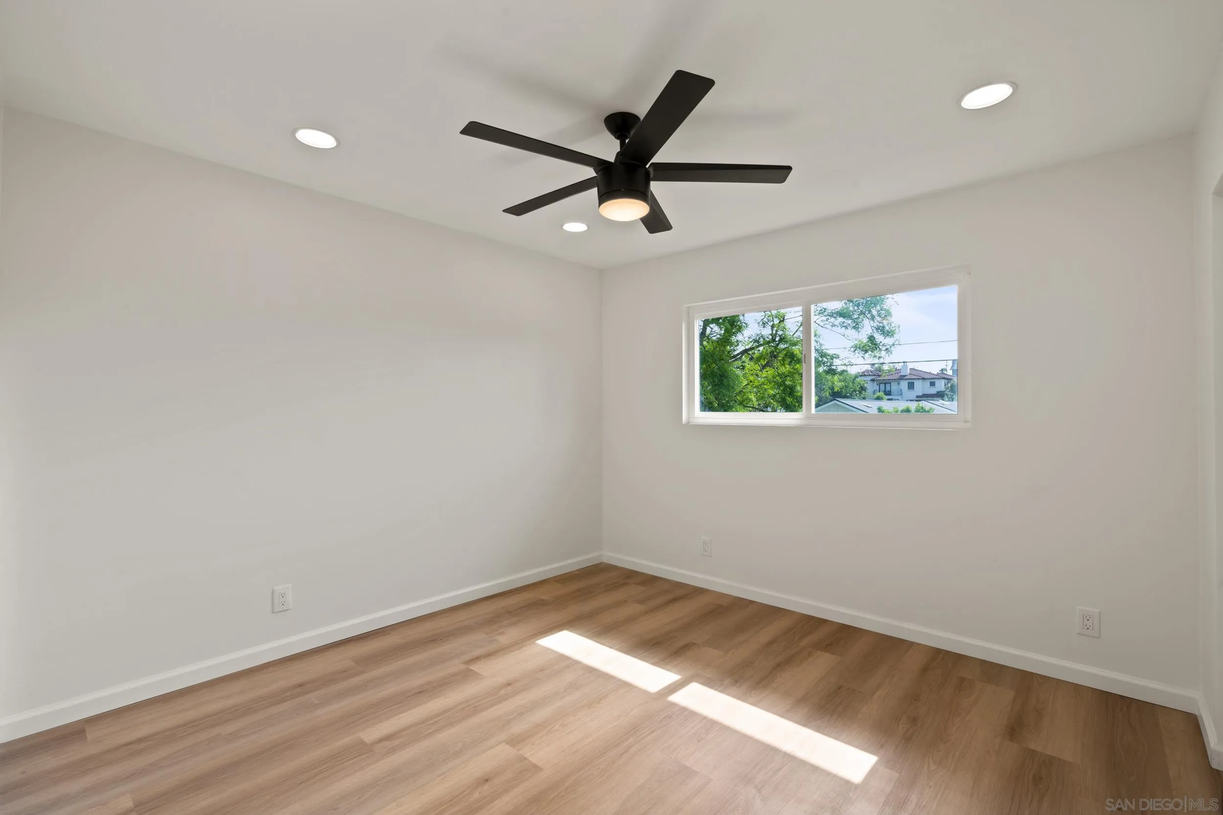 1144 Stratford Drive Encinitas, CA 92024 - Photo 21 of 39 a view of a big room with wooden floor and windows