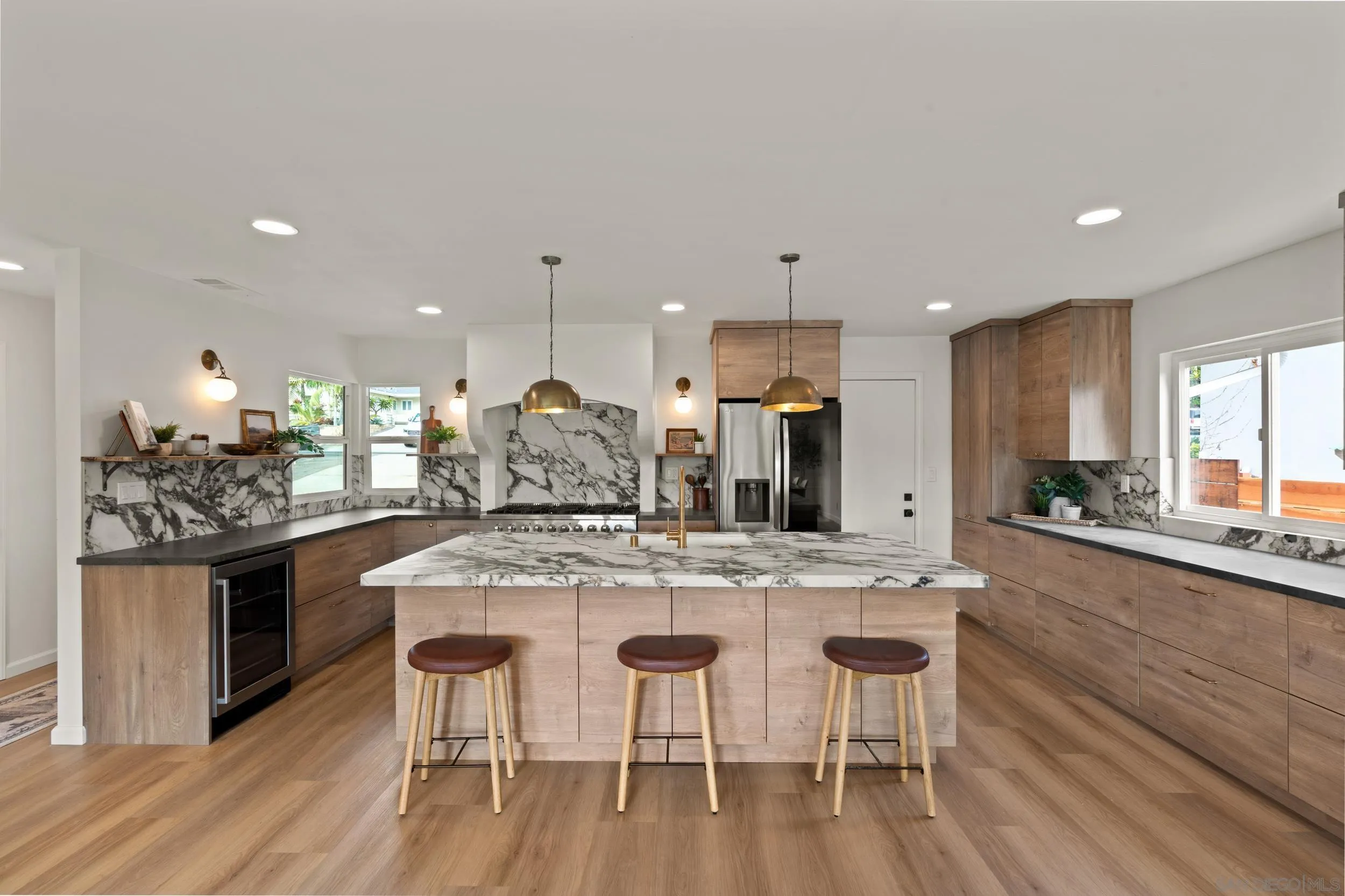 1144 Stratford Drive Encinitas, CA 92024 - Photo 6 of 39 a kitchen with stainless steel appliances granite countertop a kitchen island and chairs in it