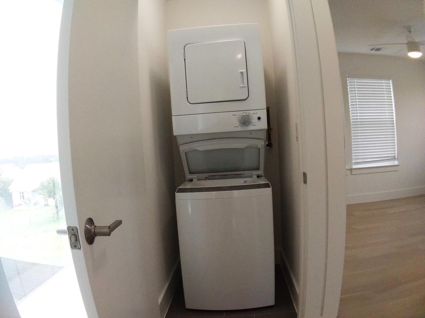 7309 Bennett Avenue, Unit B Austin, TX 78752 - Photo 12 of 16 Laundry area featuring stacked washing machine and dryer, plenty of natural light, ceiling fan, and wood finished floors