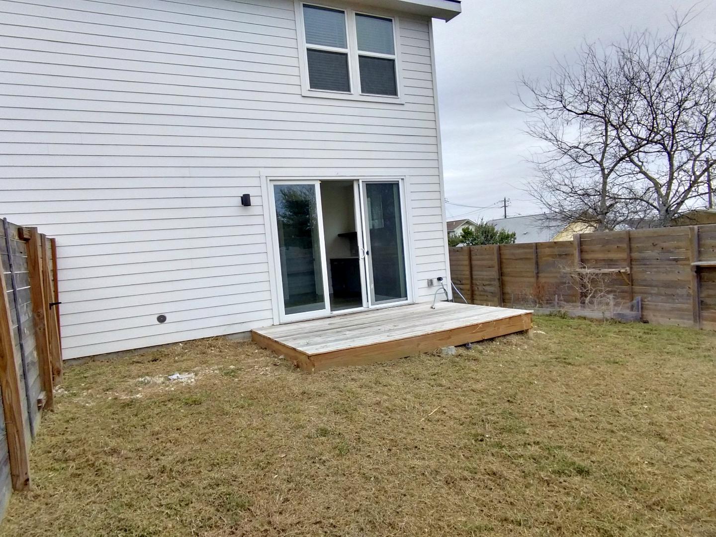 7309 Bennett Avenue, Unit B Austin, TX 78752 - Photo 14 of 16 Rear view of property featuring a fenced backyard and a wooden deck
