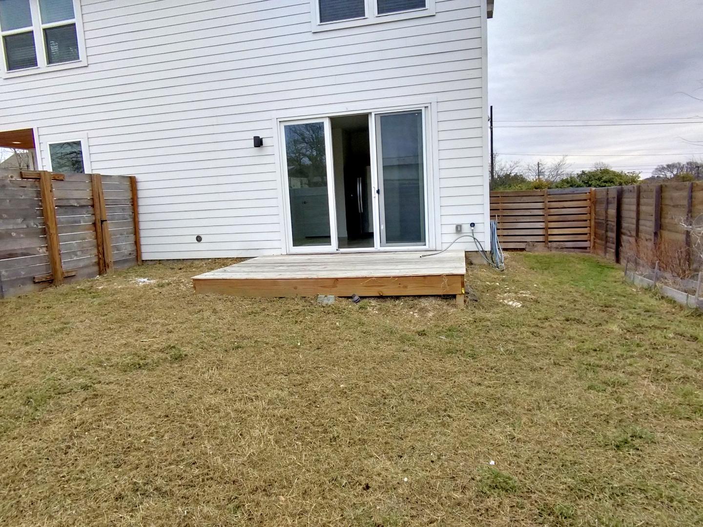 7309 Bennett Avenue, Unit B Austin, TX 78752 - Photo 15 of 16 Rear view of property featuring a fenced backyard and a deck