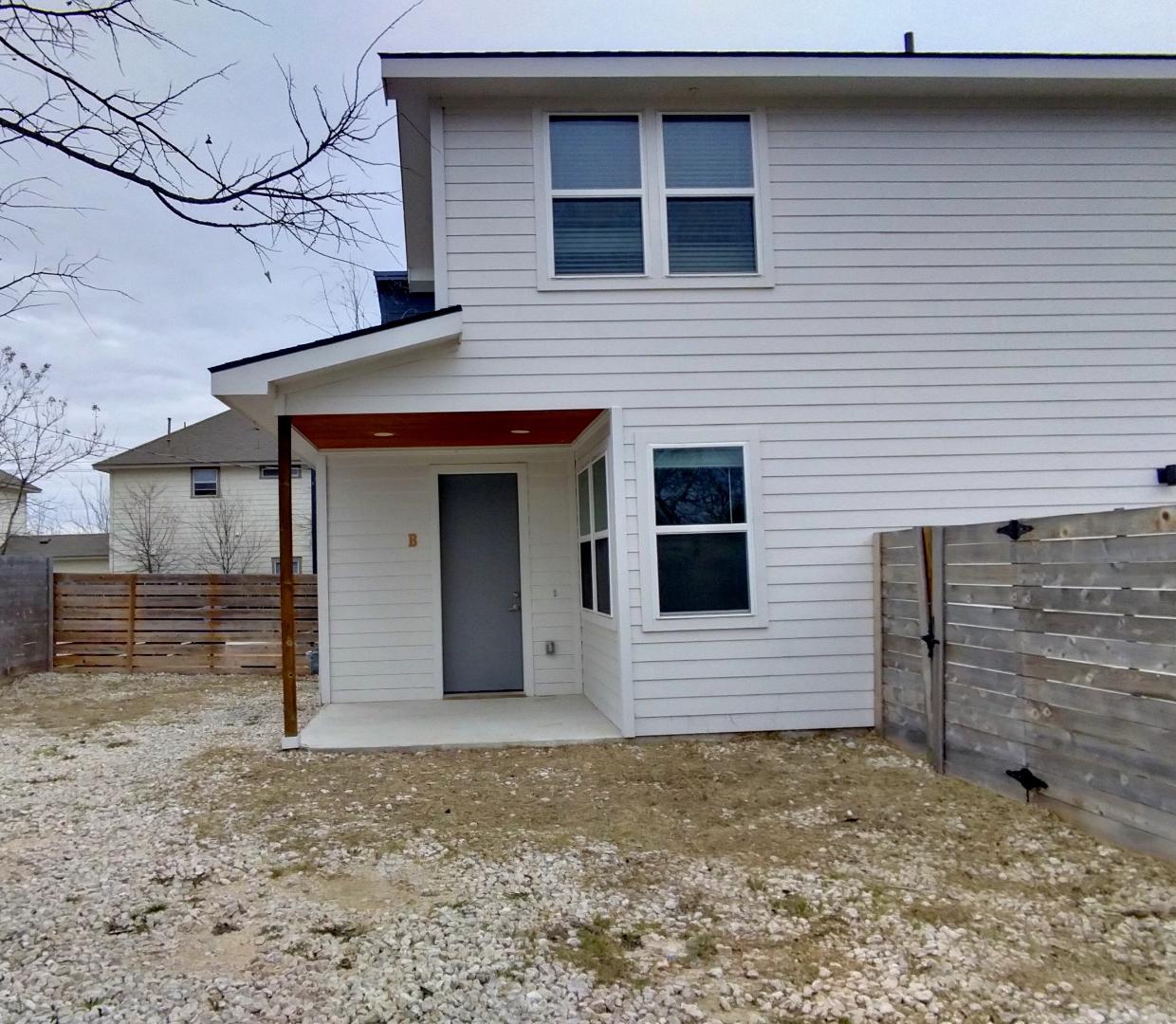 7309 Bennett Avenue, Unit B Austin, TX 78752 - Photo 16 of 16 Back of property with a patio area and a fenced backyard