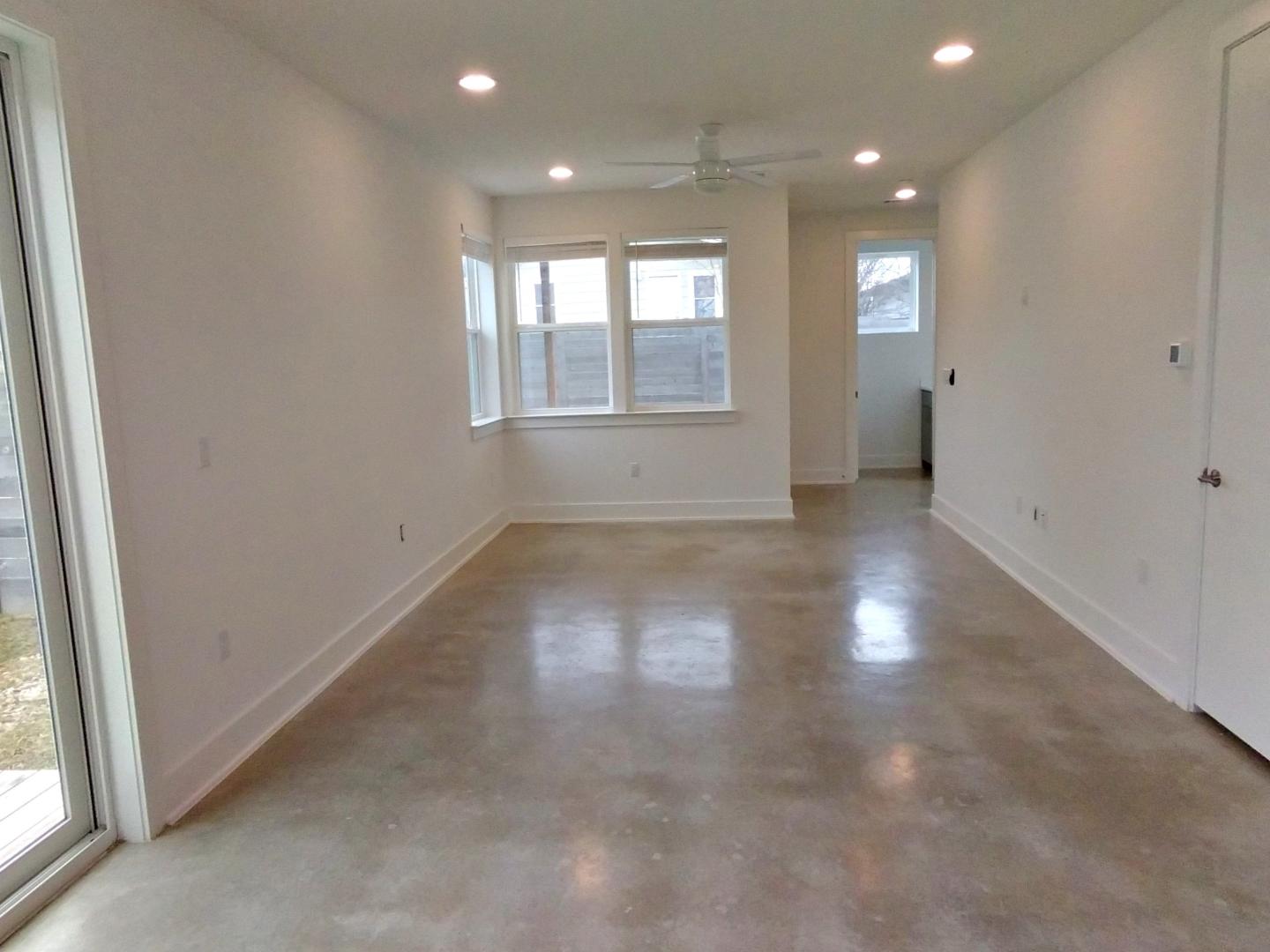 7309 Bennett Avenue, Unit B Austin, TX 78752 - Photo 2 of 16 Empty room with healthy amount of natural light, recessed lighting, concrete flooring, and a ceiling fan