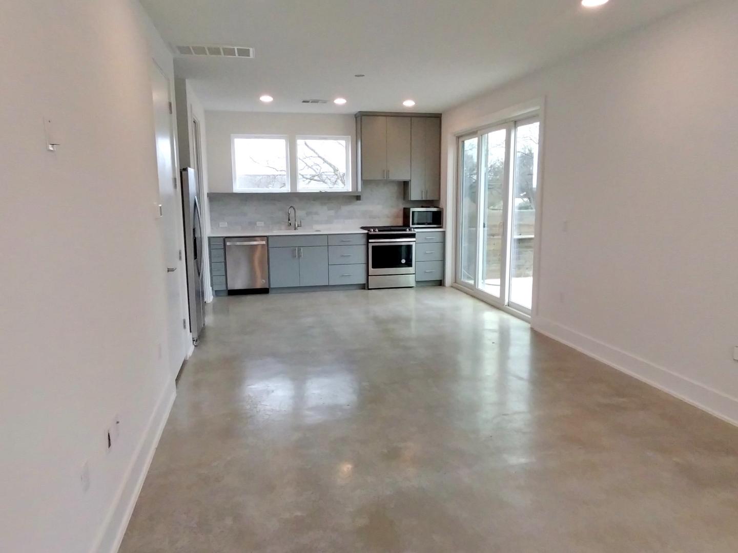 7309 Bennett Avenue, Unit B Austin, TX 78752 - Photo 4 of 16 Kitchen with stainless steel appliances, light countertops, gray cabinets, plenty of natural light, and recessed lighting