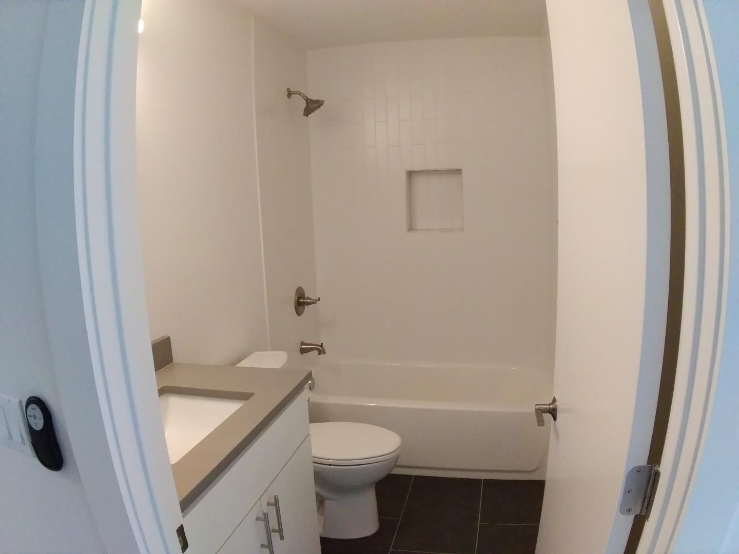 7309 Bennett Avenue, Unit B Austin, TX 78752 - Photo 9 of 16 Full bath featuring vanity, dark tile patterned floors, and bathtub / shower combination