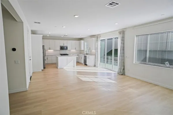 a view of a kitchen with a stove top oven and cabinets