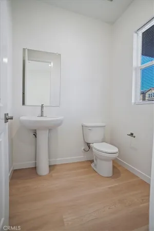 a view of staircase with white walls and door
