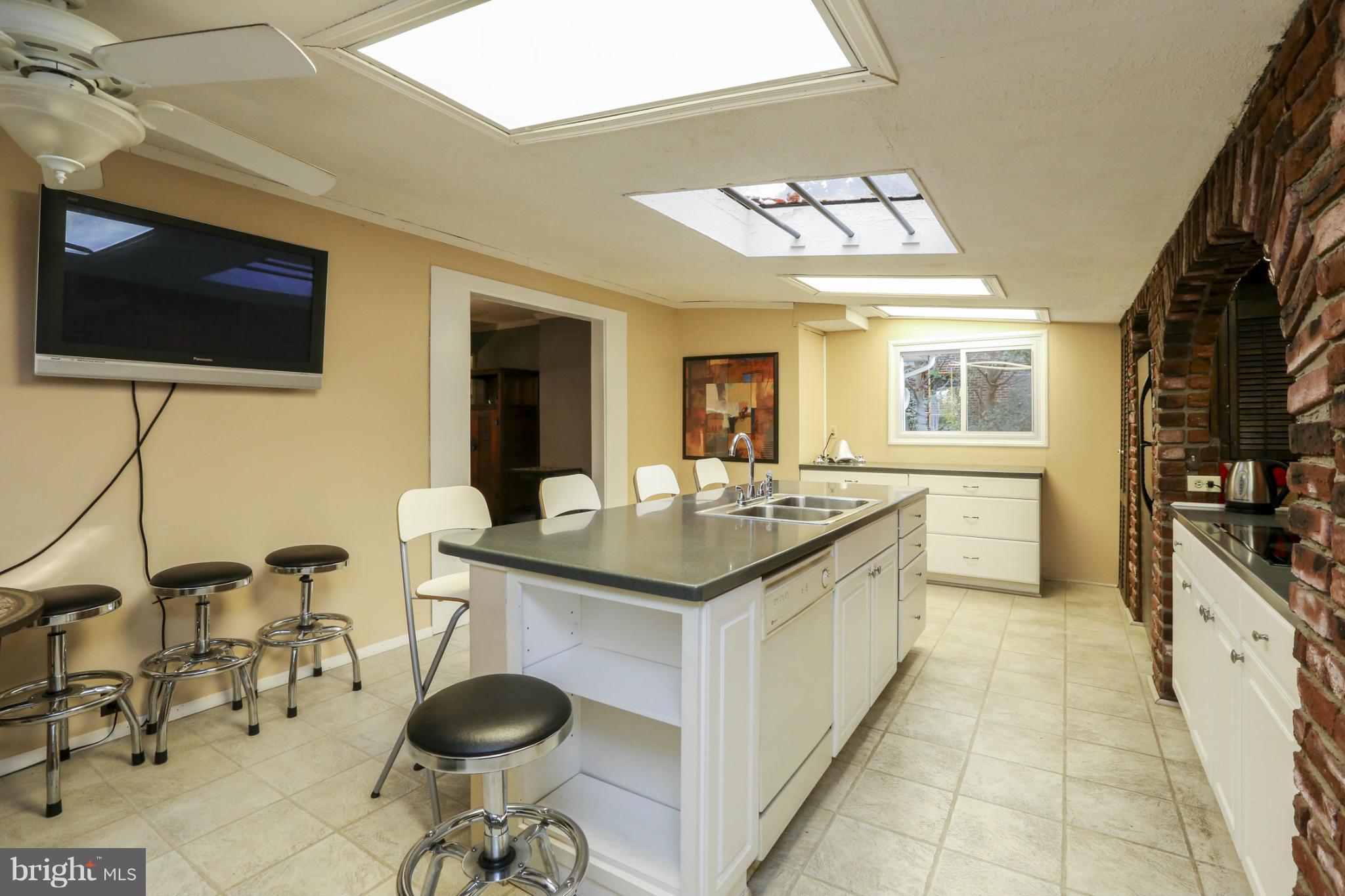 6730 Queens Ferry Road Baltimore, MD 21239 - Photo 11 of 21 a kitchen with a sink and a stove top oven with wooden floor