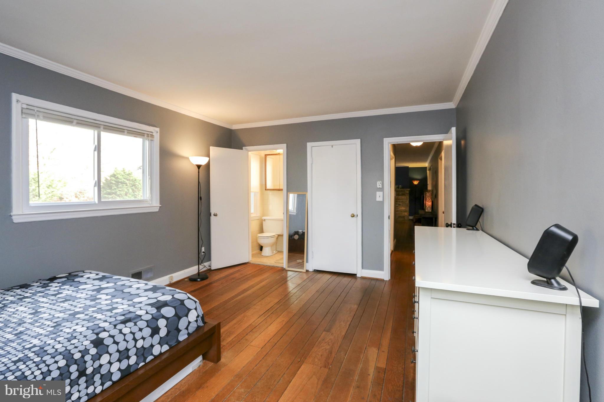 6730 Queens Ferry Road Baltimore, MD 21239 - Photo 15 of 21 a bedroom with bed and wooden floor