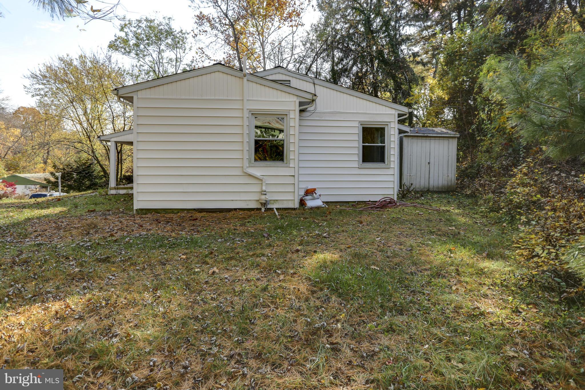 6730 Queens Ferry Road Baltimore, MD 21239 - Photo 19 of 21 a view of a house with a yard