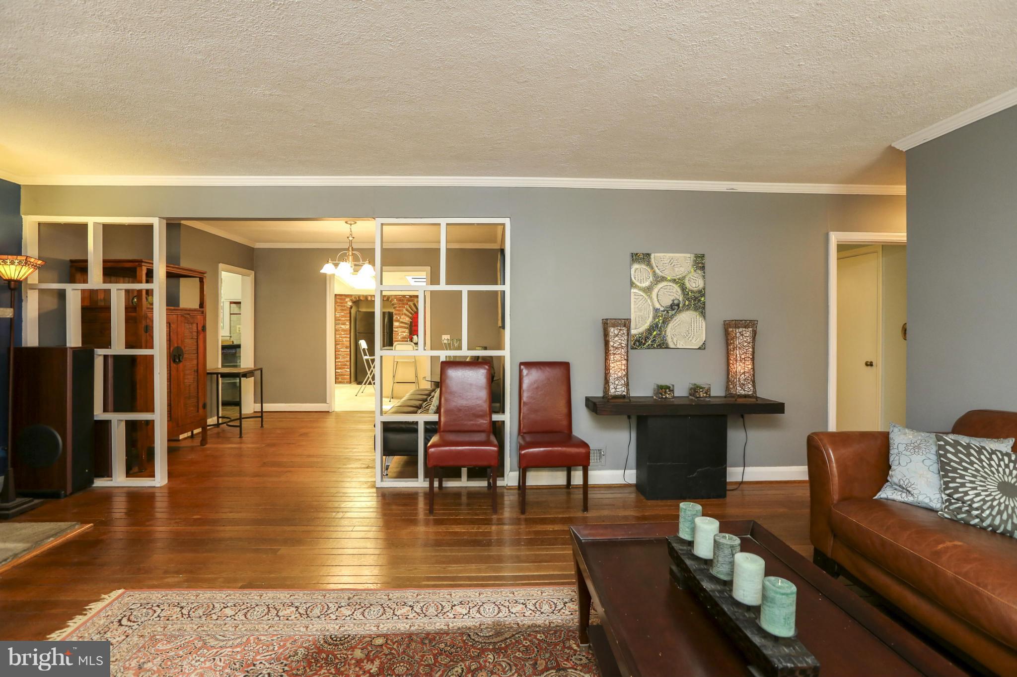 6730 Queens Ferry Road Baltimore, MD 21239 - Photo 4 of 21 a living room with furniture and wooden floor