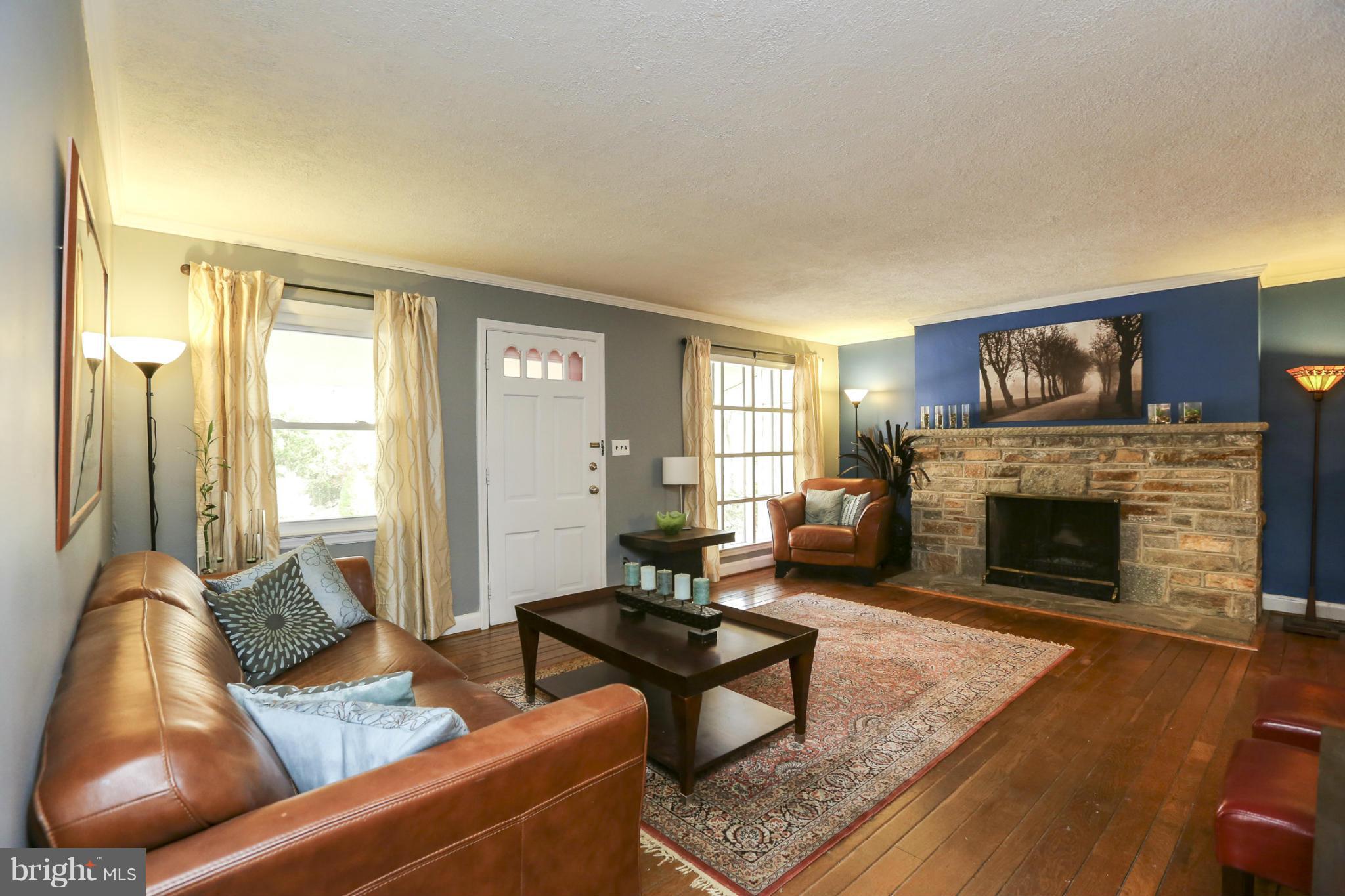 6730 Queens Ferry Road Baltimore, MD 21239 - Photo 6 of 21 a living room with furniture and a fireplace