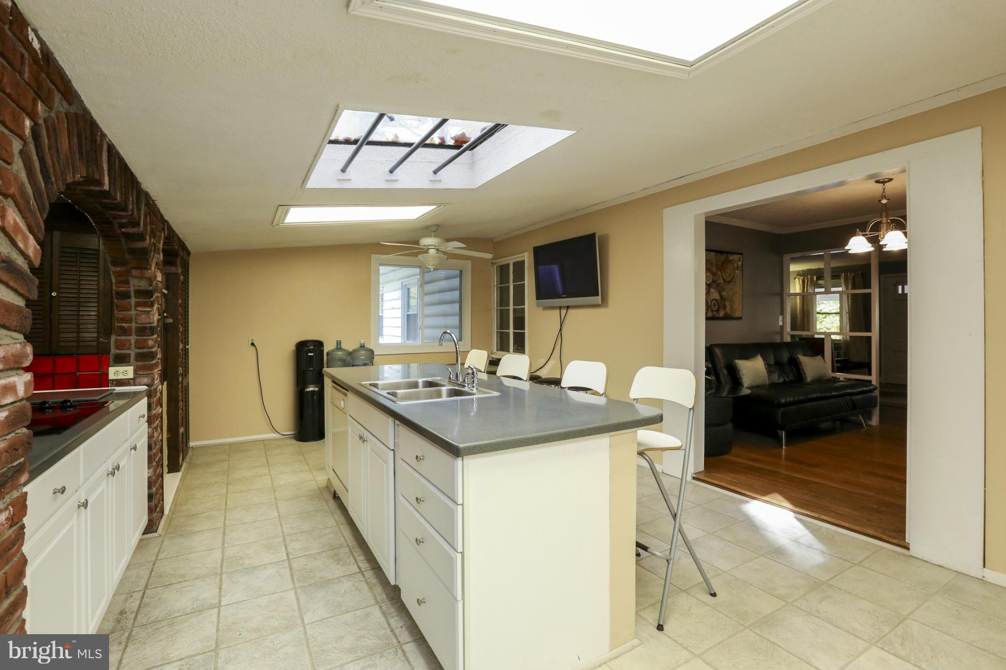 6730 Queens Ferry Road Baltimore, MD 21239 - Photo 10 of 21 a kitchen with stainless steel appliances granite countertop a sink and cabinets