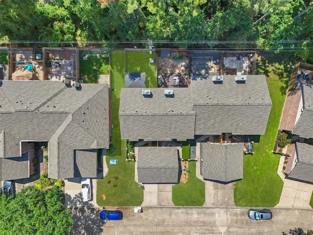 an aerial view of a house with garden space and outdoor seating