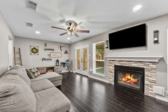a living room with furniture a fireplace and a flat screen tv