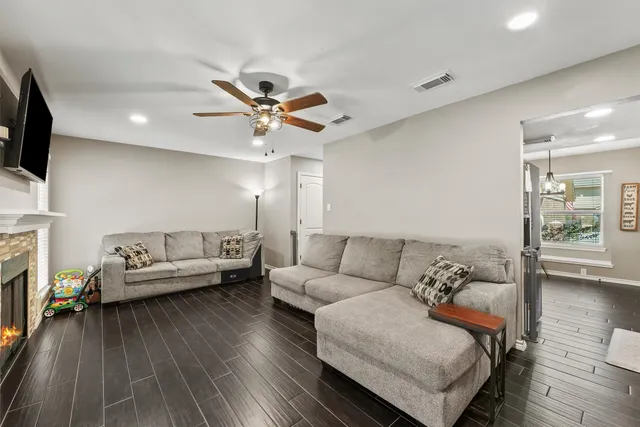 a living room with furniture and a wooden floor