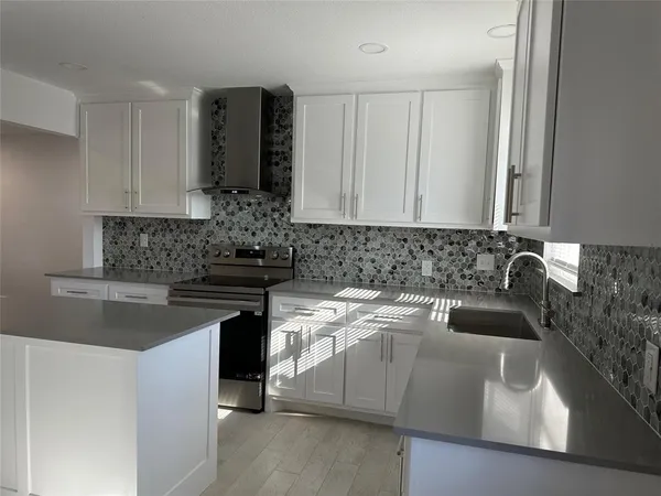 a kitchen with a sink and cabinets
